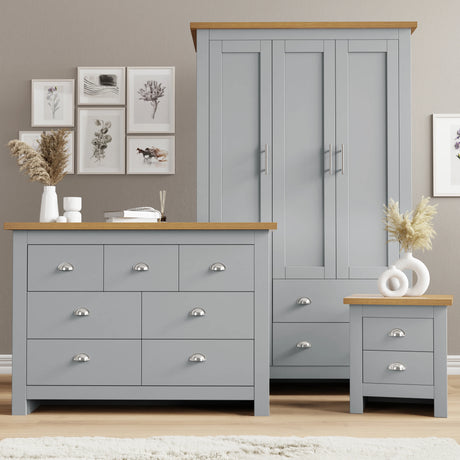 Grey wardrobe and drawer set with bedside table in shaker style for a country look in modern UK interiors.