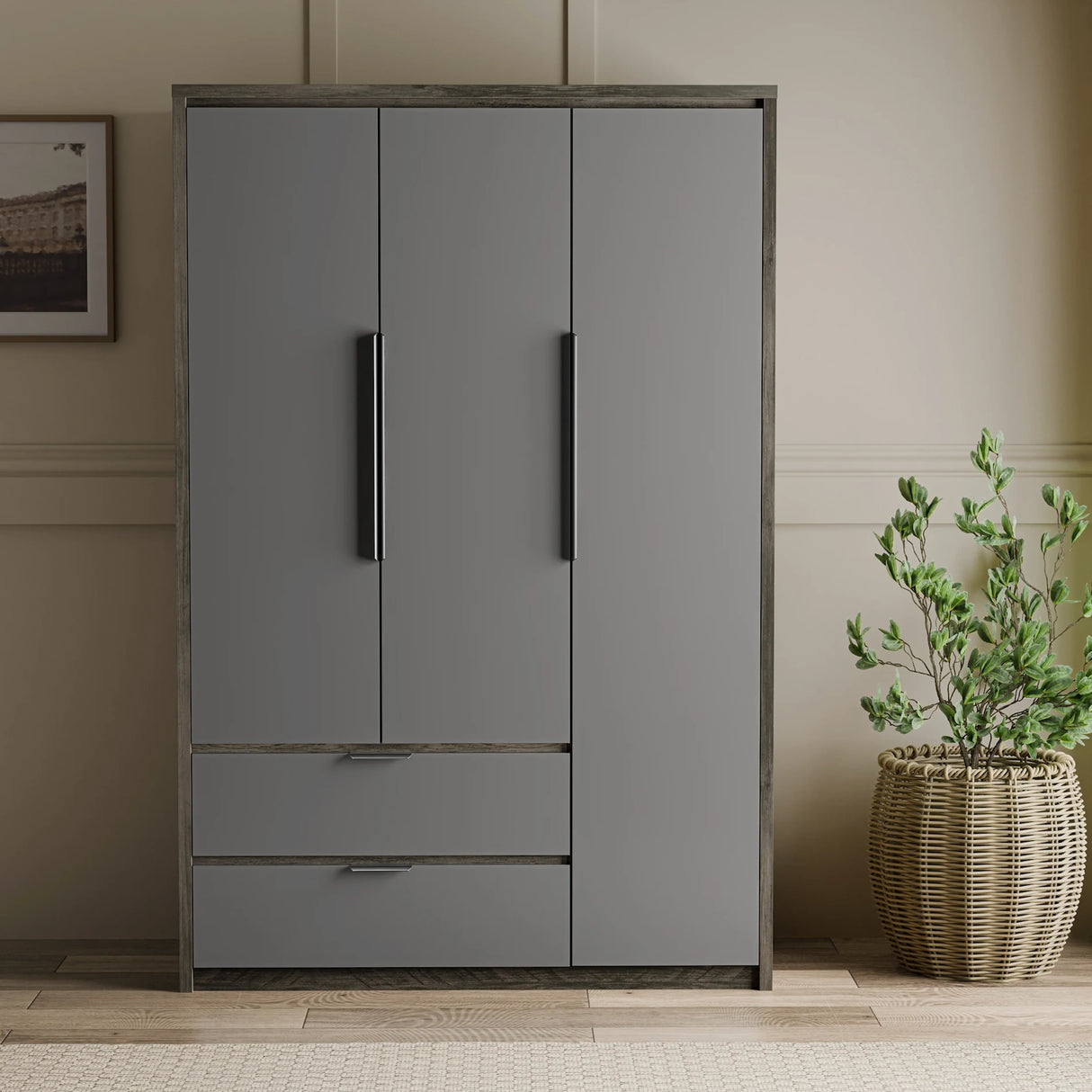 Gray wardrobe with two doors and two drawers in a room setting with a plant.