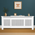 White radiator cover with decorative items against a blue wall