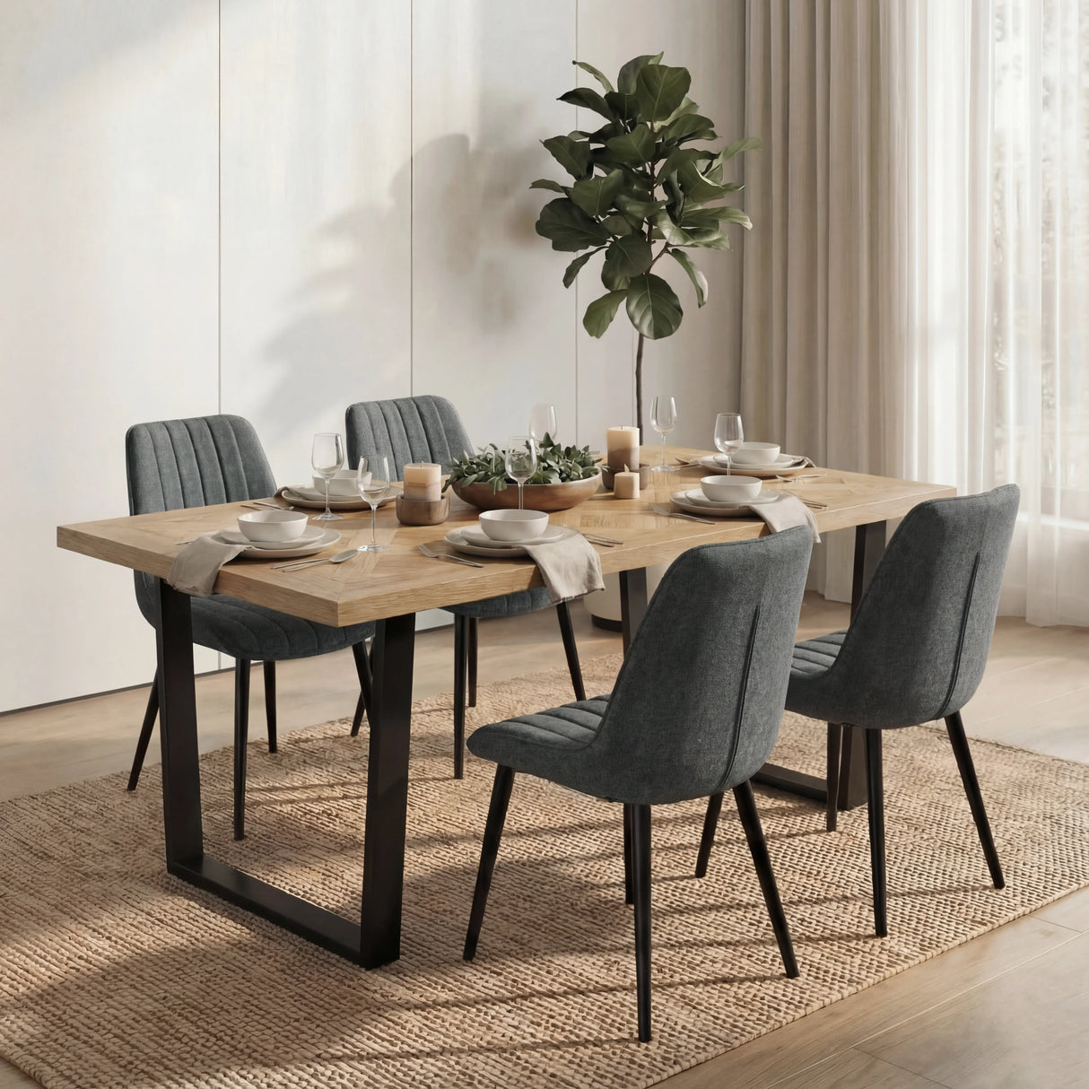 Aldridge dining table with candles, cups and wine glasses on top and 4 grey upholstered chairs in a warm and stylish setting.