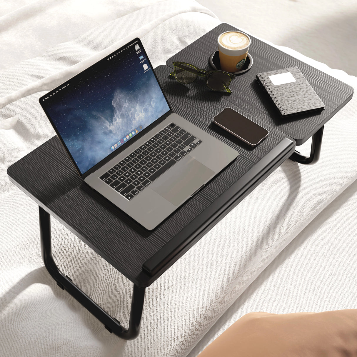 Portable folding laptop desk in black with height adjustable legs and built-in cup holder, ideal for bed or sofa use. DHS multifunctional table for home office.