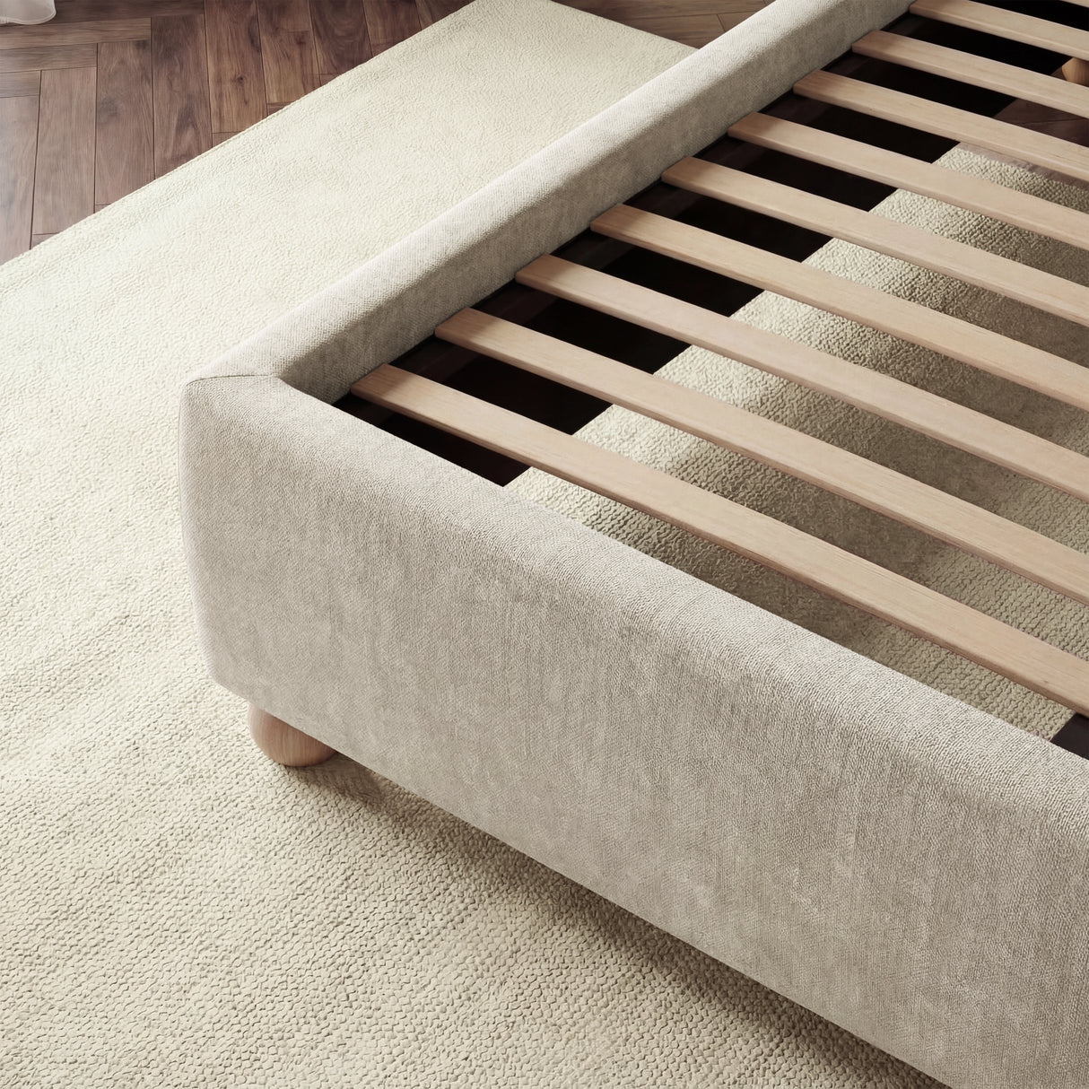 Velvet beige upholstered king bed frame featuring sturdy wooden slats for mattress support