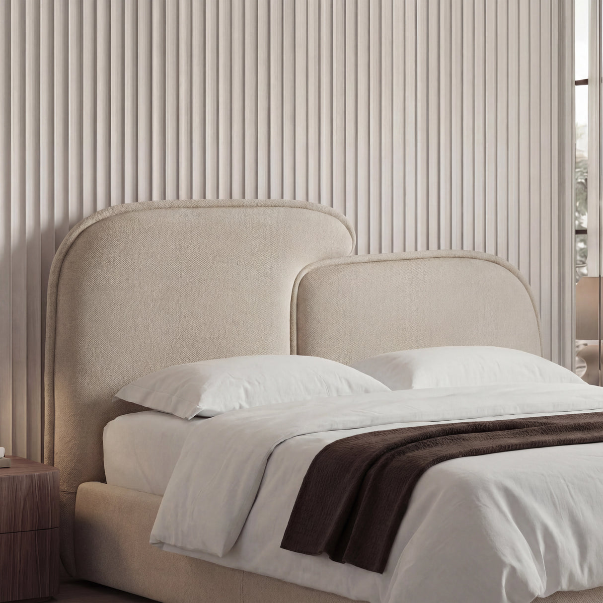 Close-up of softly contoured corner upholstery with visible beige texture and smooth stitching lines