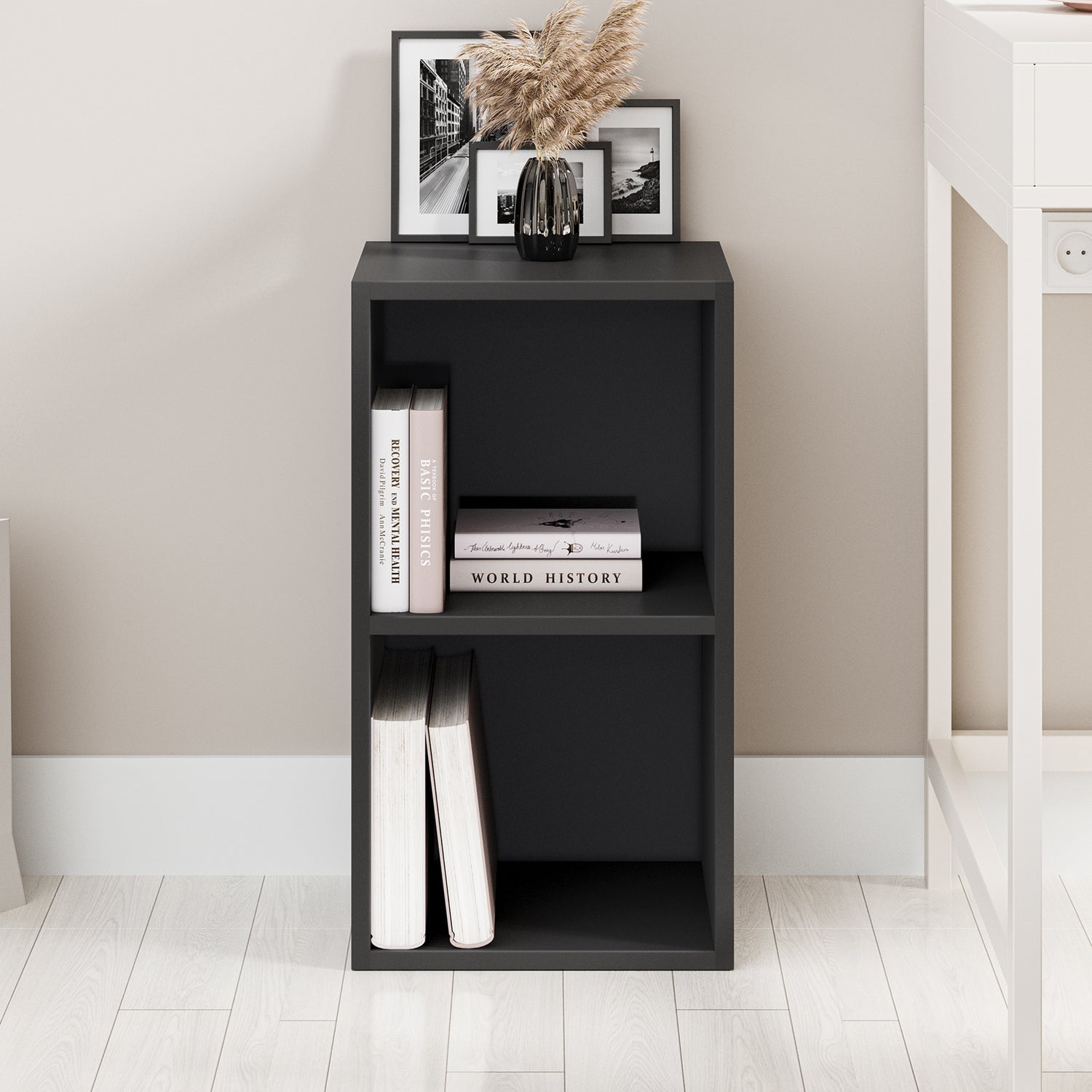 front view of sleek 2 tier black shelving unit styled minimally, adding clean lines to any room corner