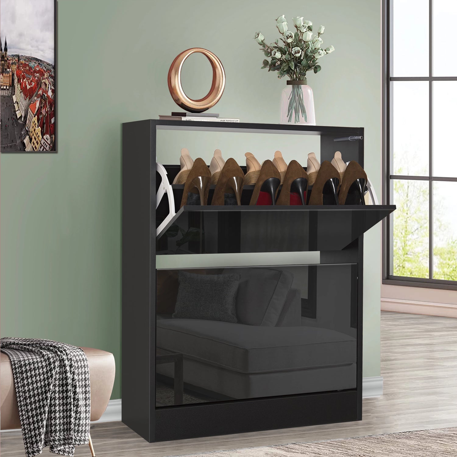 A 2 tier black gloss shoe cabinet with top drawer pulled down to display assorted shoes in use