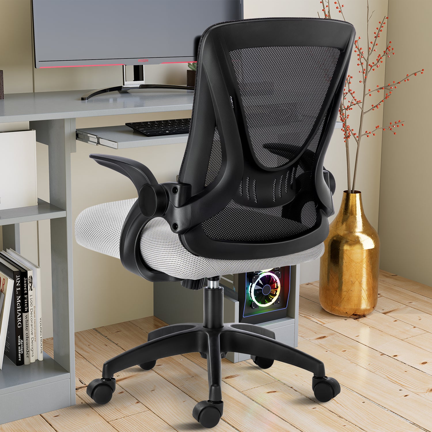 Black and grey desk chair with mesh backrest, offering ergonomic support near your PC workstation.