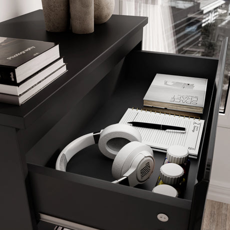 Close-up of open drawer in black high gloss chest with headphones, books, and accessories, part of the 3 Piece Bedroom Set.