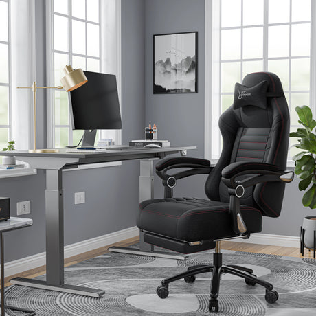 Black office chair in a modern office setting with a desk and lamp.