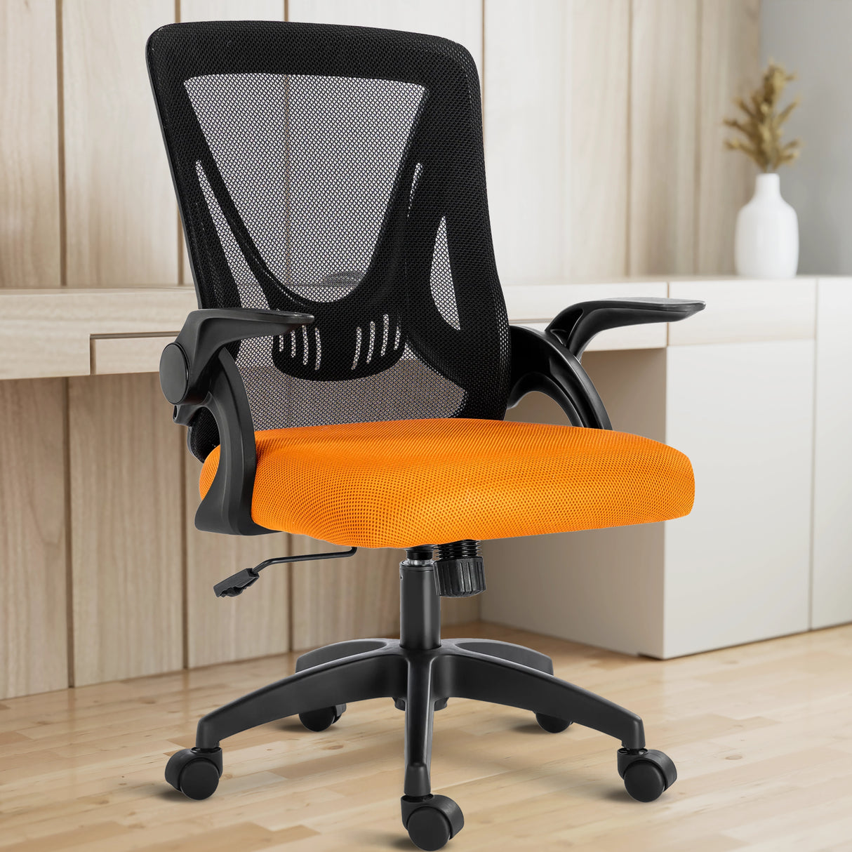 A black and orange mesh chair in a home office is paired with a working desk, perfect for long hours of sitting.