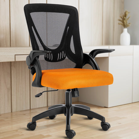 A black and orange mesh chair in a home office is paired with a working desk, perfect for long hours of sitting.