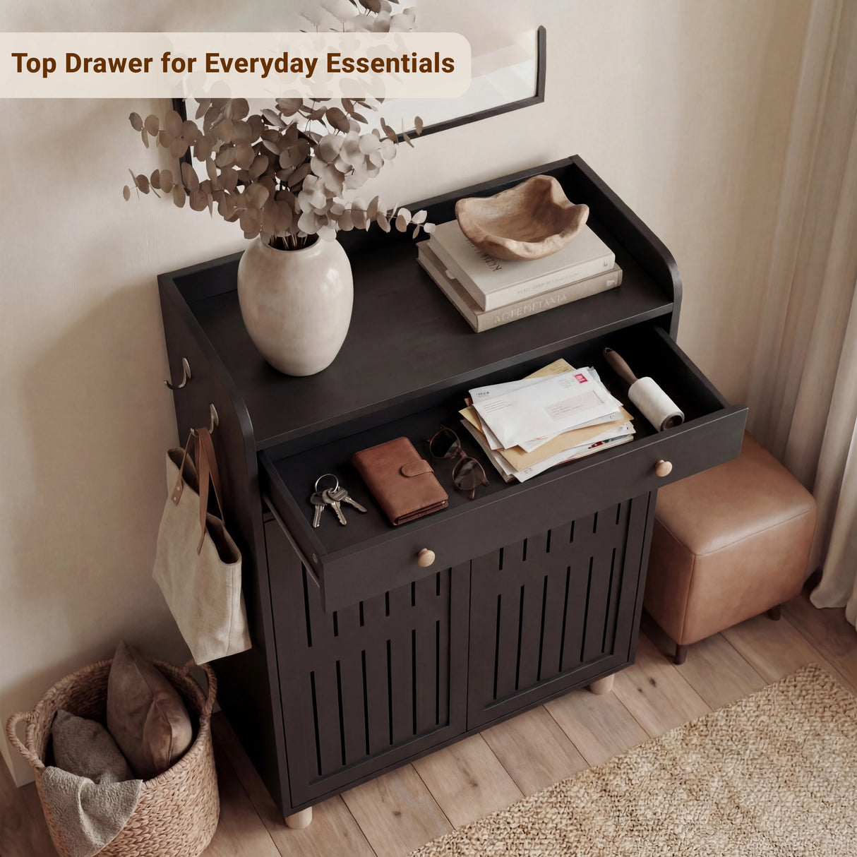 Overhead view of a shallow upper drawer holding small everyday items positioned above a multi-shelf black footwear cabinet
