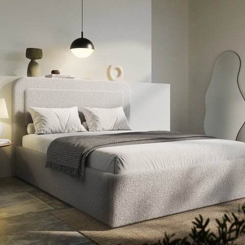 Boucle upholstered ottoman storage bed with curved headboard in soft grey fabric, featuring gas-lift storage and modern minimalist design.
