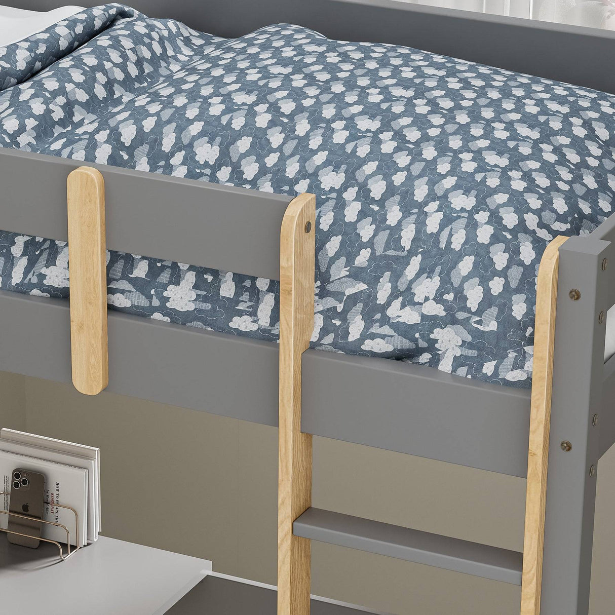 close-up of bunk bed wooden ladder rails and blue bedding featuring white cloud pattern