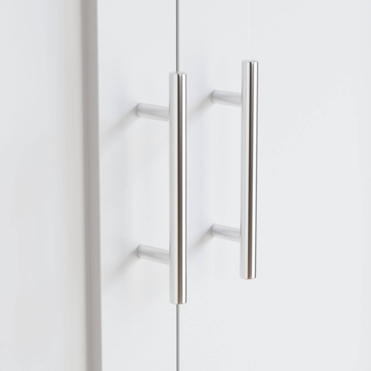 Close-up of sleek silver handles on Shaker 2 Door Wardrobe, part of a modern white bedroom furniture set for stylish storage solutions.