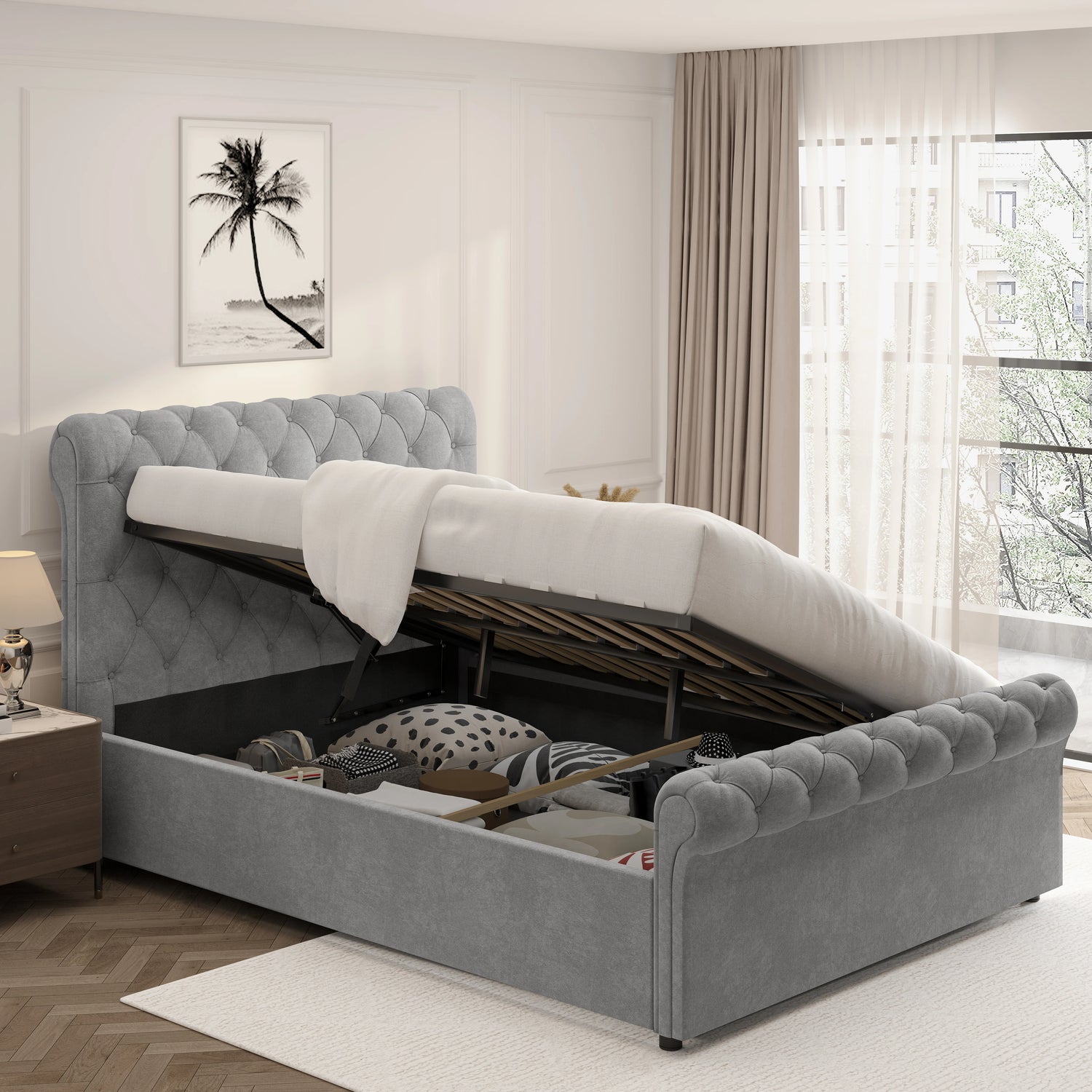 Chesterfield Ottoman Storage Bed in grey with side lift mechanism, showcasing under-bed storage filled with bedding and accessories. Elegant tufted headboard design.