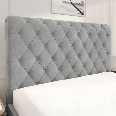 Gray tufted headboard in a bedroom setting with a framed picture on the wall.