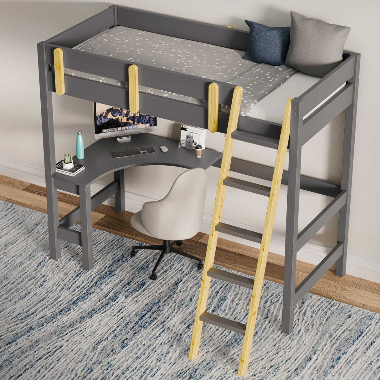 Childrens bunk bed with desk underneath and wooden ladder placed against a wall on a blue patterned rug