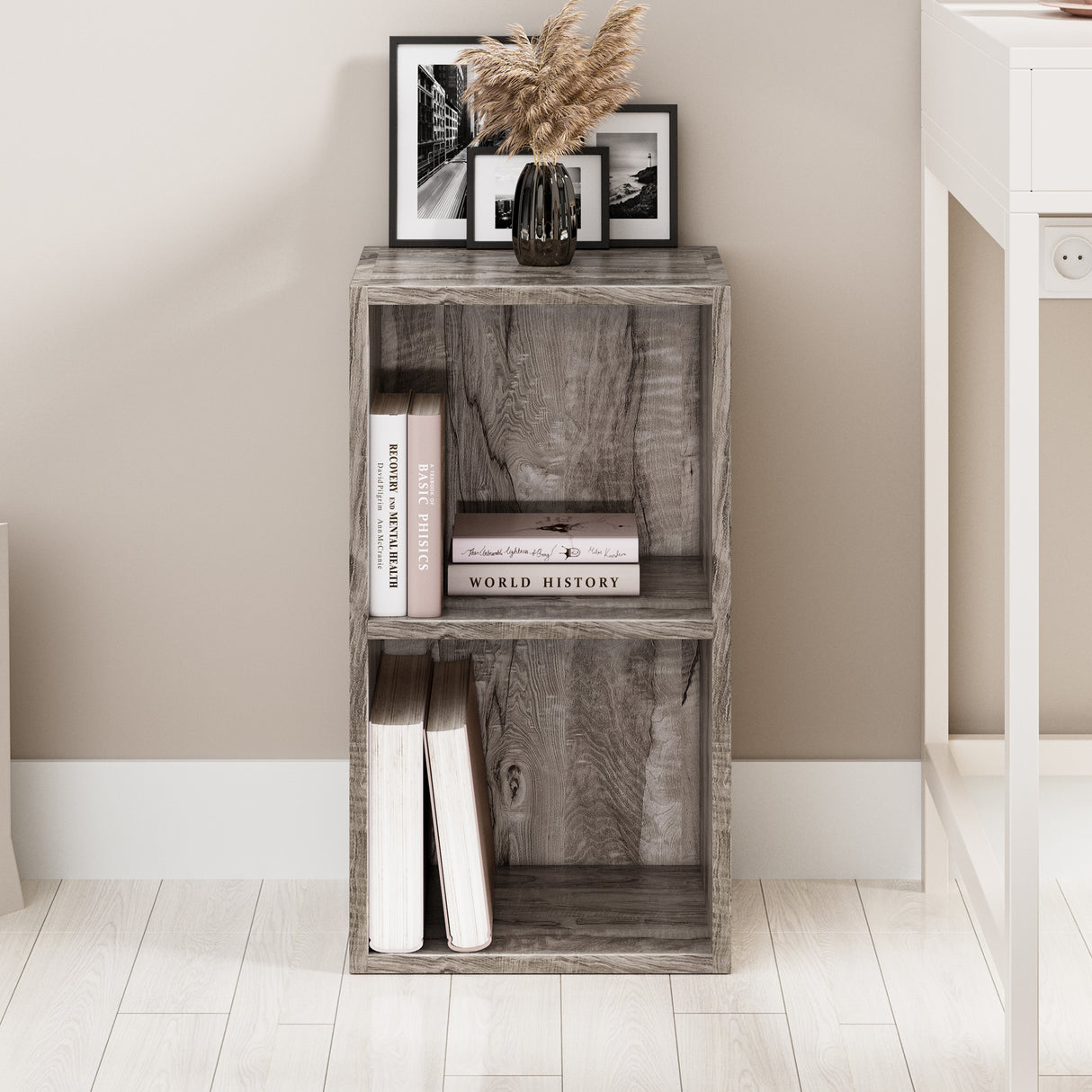 front view of coach wood corner bookcase with books and decor, perfect for utilising awkward corners