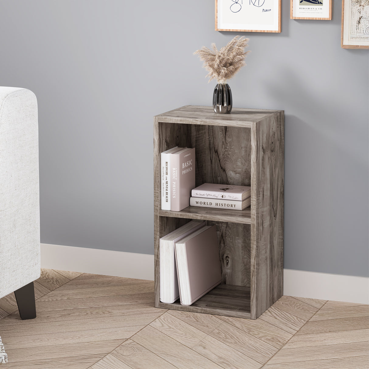 angled front view of 2 tier coach wood rustic bookcase featuring natural grain and styled with books and art