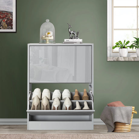 front view of grey gloss small shoe cabinet with soft reflection of nearby living room furniture