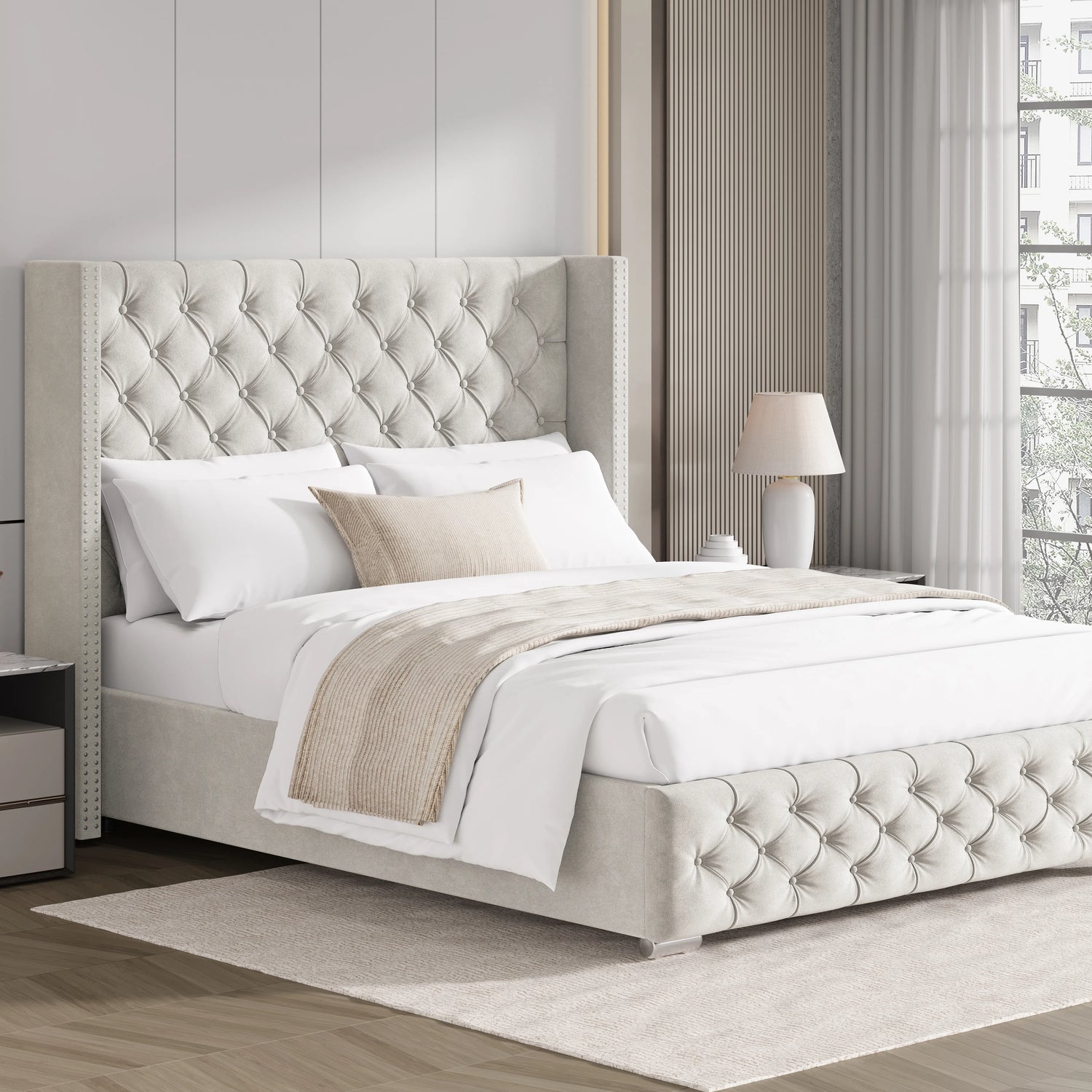 Beige double velvet ottoman bed with cross pattern and winged headboard, styled in a soft neutral bedroom.