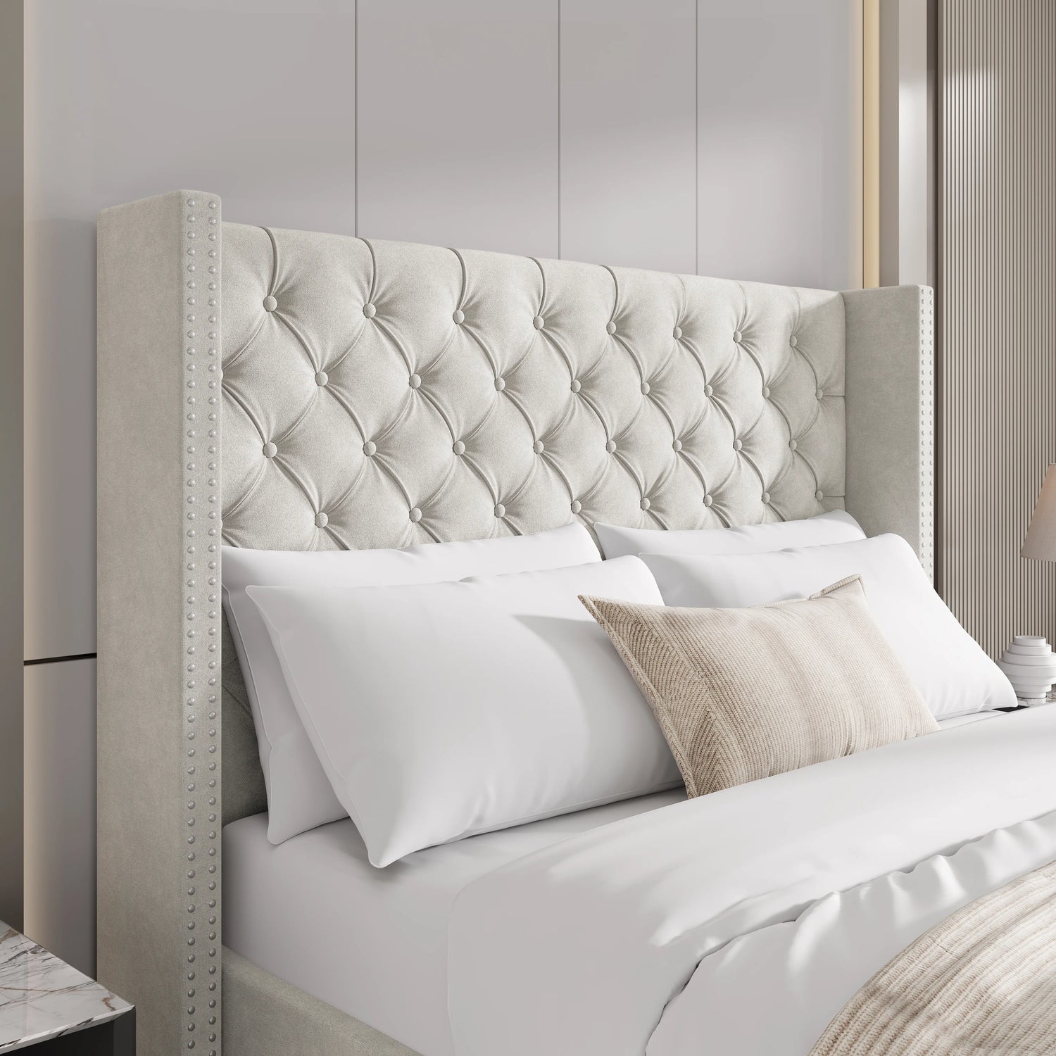 Close-up of beige small double velvet headboard with tufted cross pattern and studded winged design.
