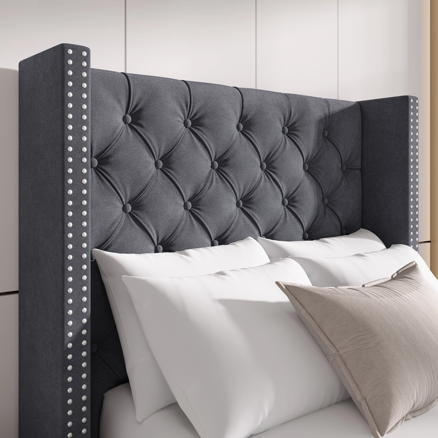 Close-up of dark grey velvet winged headboard with tufted cross pattern and studded detailing for a luxurious look.