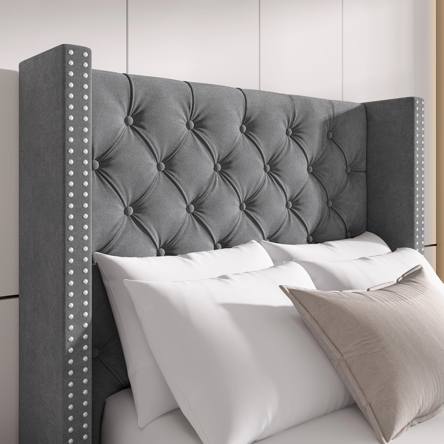 Close-up of light grey velvet headboard with cross tufting and studded winged sides, perfect for luxury interiors.