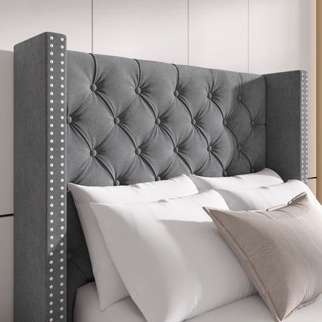 Close-up of light grey velvet headboard with cross tufting and studded winged sides, perfect for luxury interiors.