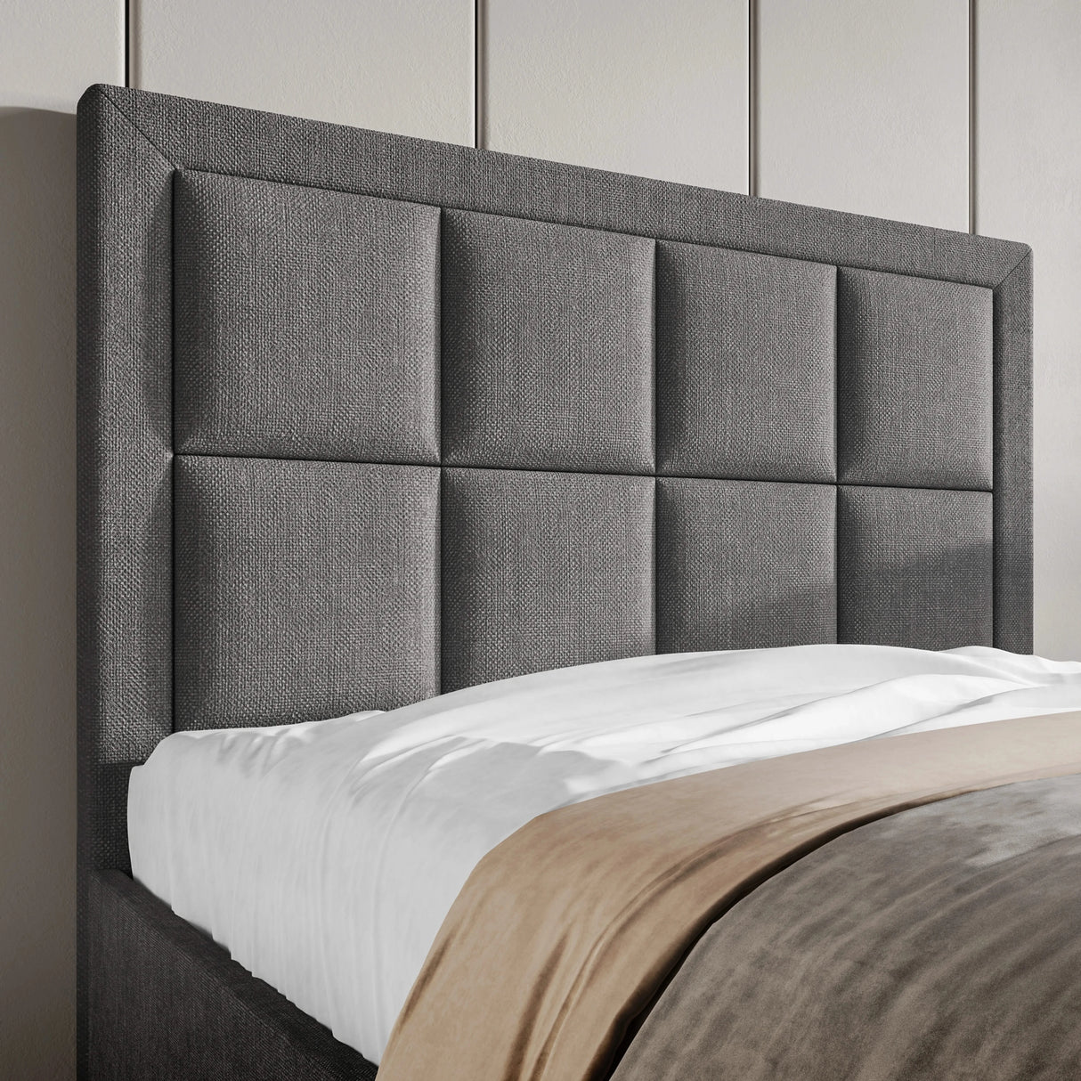 Detail view of the dark grey upholstered headboard on the single ottoman bed, featuring a modern stitched panel design.