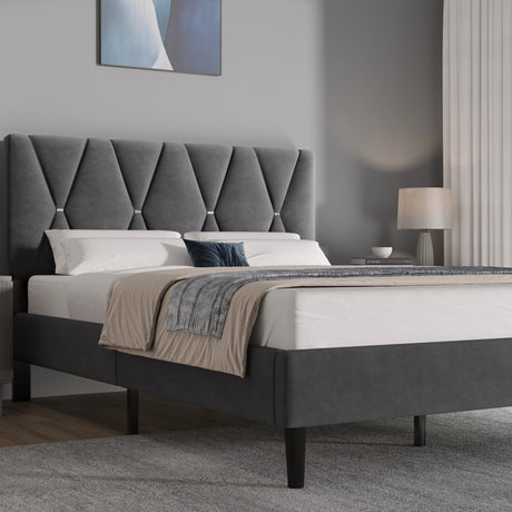 Grey upholstered bed with tufted headboard in a bedroom setting.