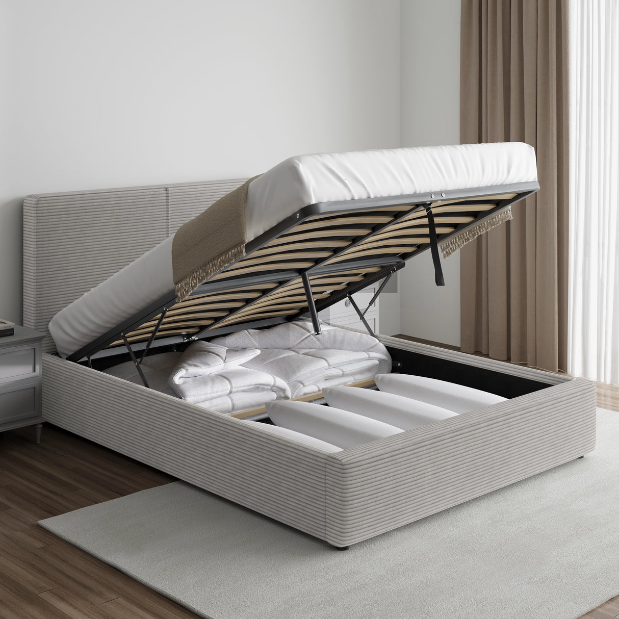 Corduroy ribbed velvet upholstered ottoman bed frame with end lift storage in light grey, shown open with bedding stored inside. Ideal for modern bedrooms.