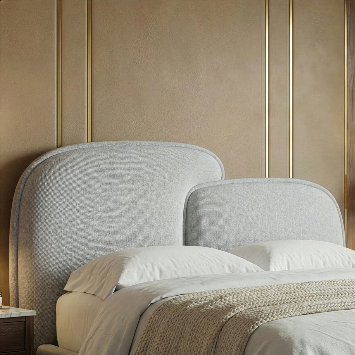 Close detail of the curved splitted grey headboard showing fabric texture and rounded top edge