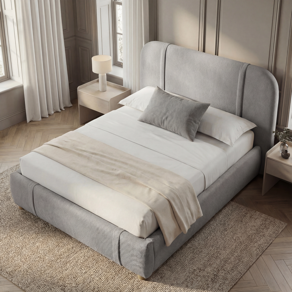 Grey fabric double bed frame positioned at a slight angle in a modern bedroom setting