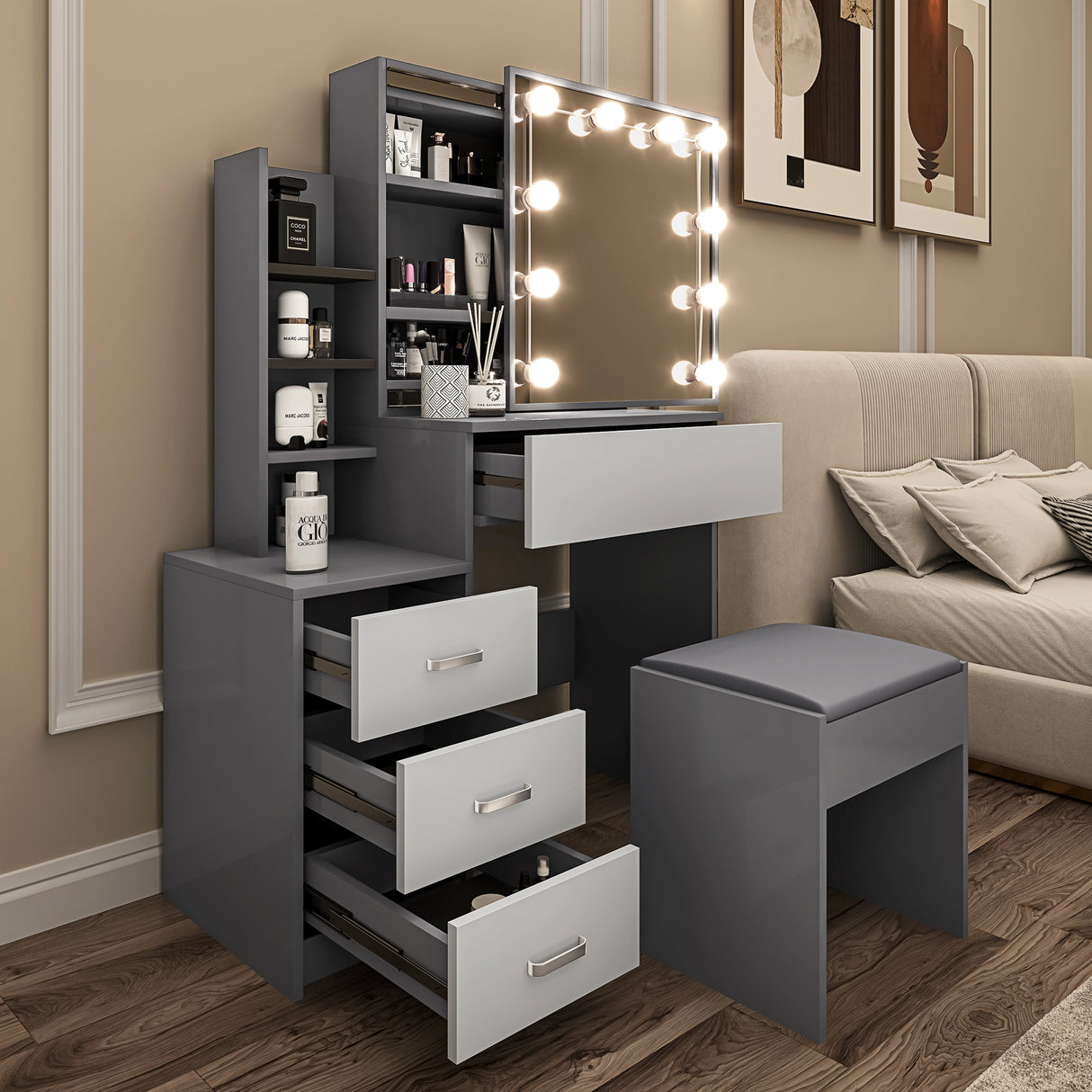 Grey vanity with mirror, lights, and white drawers placed near a bed with soft lighting, and coordinated modern decor.