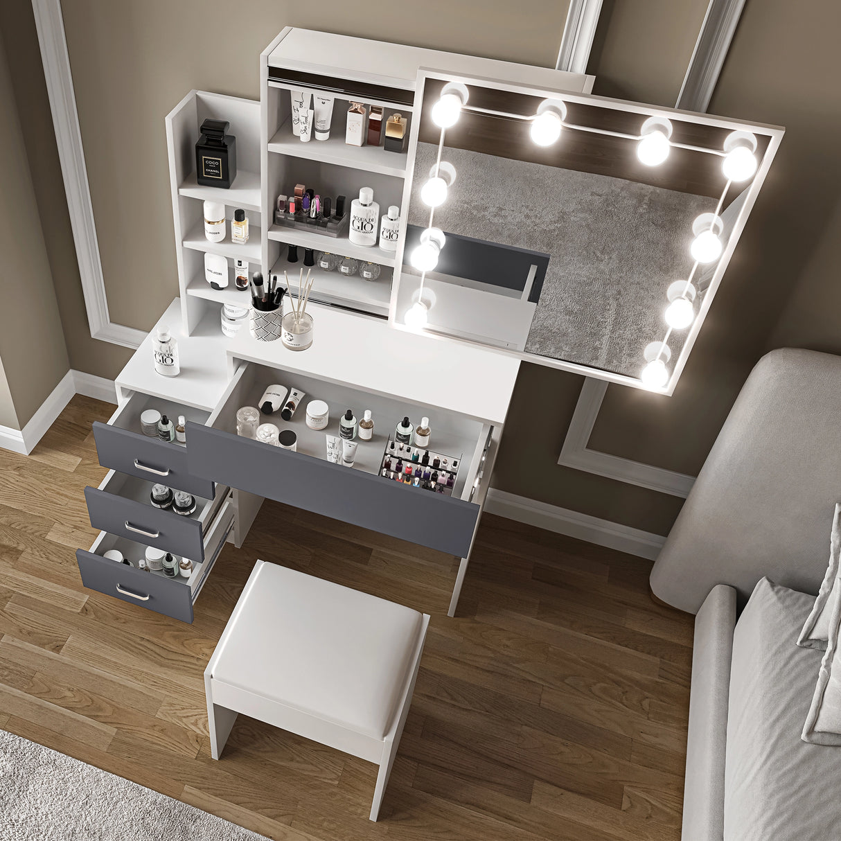 Elevated view of dressing table with mirror and lights showing organised beauty essentials in open drawers and shelves