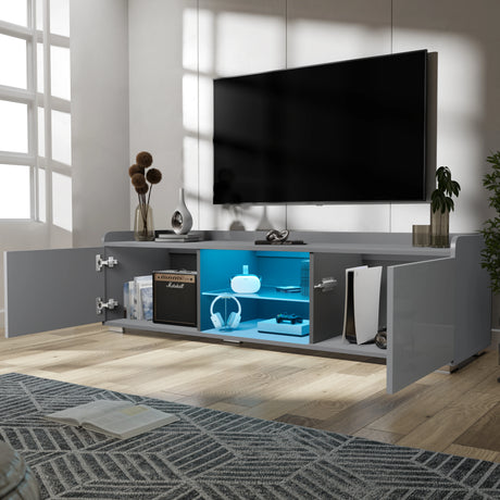 Modern entertainment console with open doors displaying electronic equipment in a living room setting.