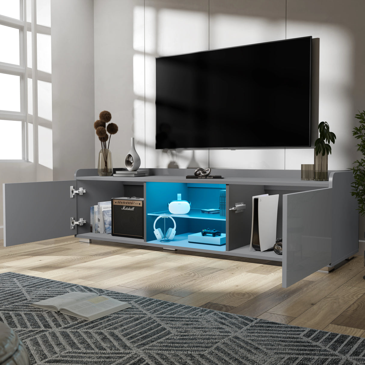 Modern entertainment console with open doors displaying electronic equipment in a living room setting.