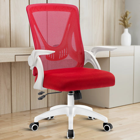 The red mesh chair in a home office, complemented by a desk, offers both comfort and style for long hours of work.