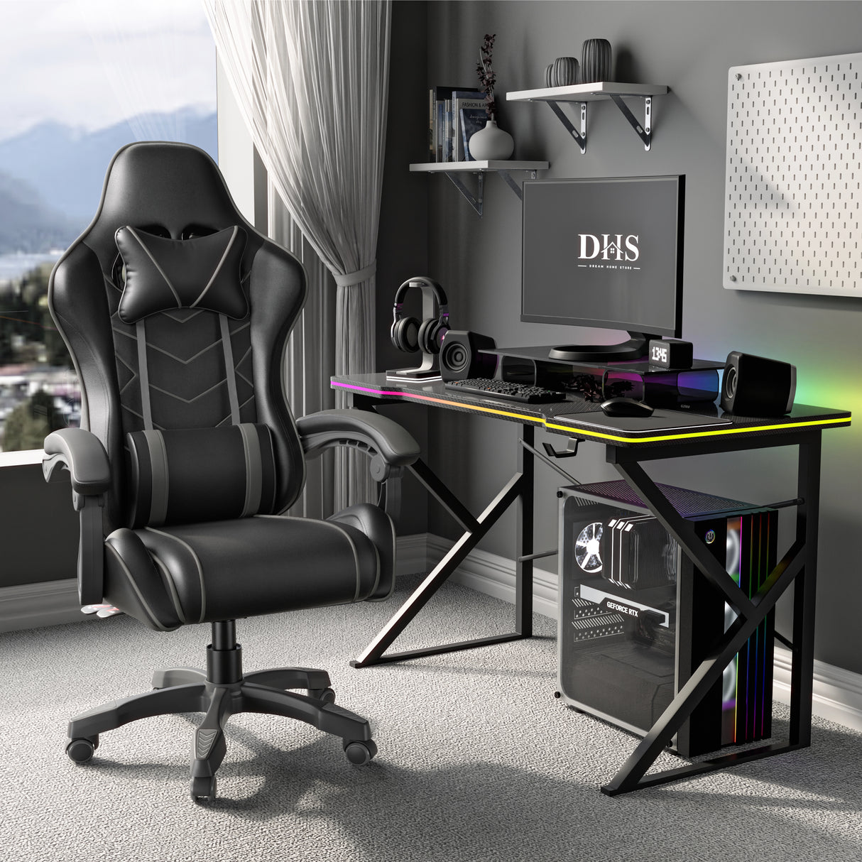 Gaming desk setup with a black and Grey chair, monitor, and computer components in a room with large windows.
