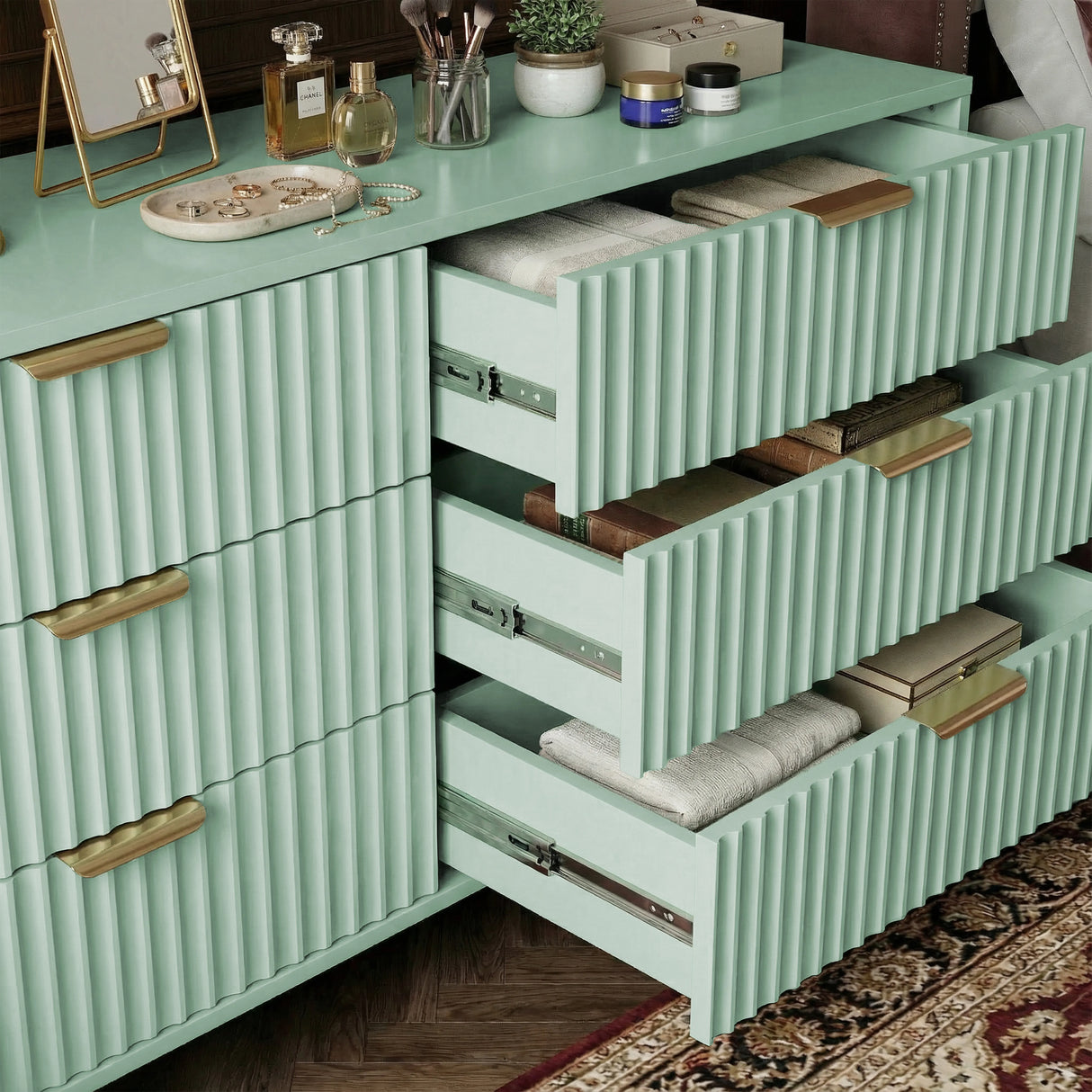 Green painted chest with three drawers extended, highlighting internal storage layout with metallic smooth runner hardware
