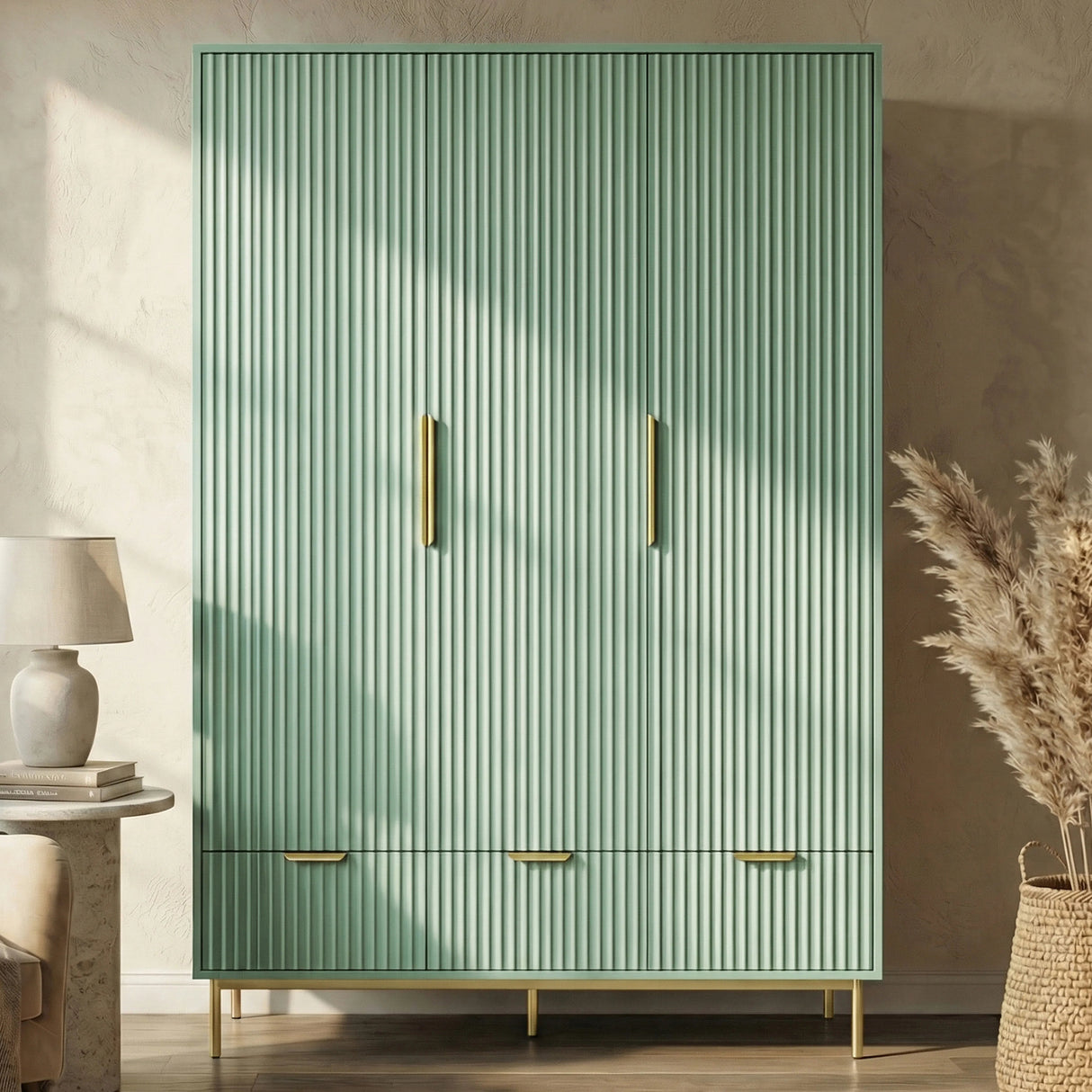 Front perspective of green 3 door wardrobe with coordinated drawer storage below and golden metal legs