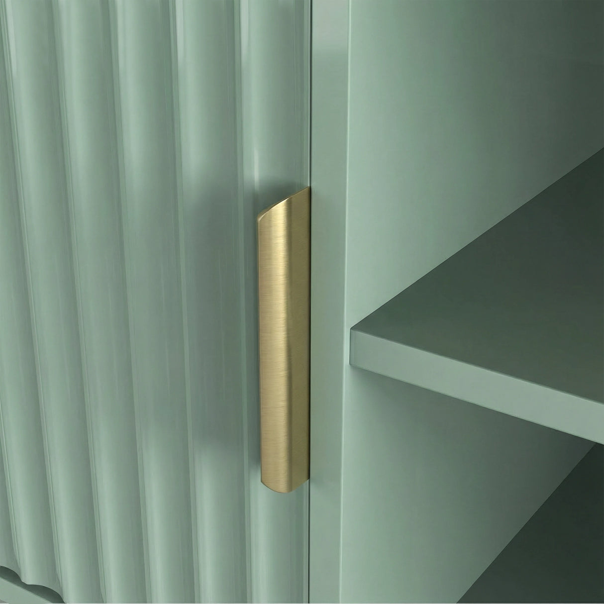 Green TV stand with open shelving and fluted cabinets for media components, finished with gold colour handles.