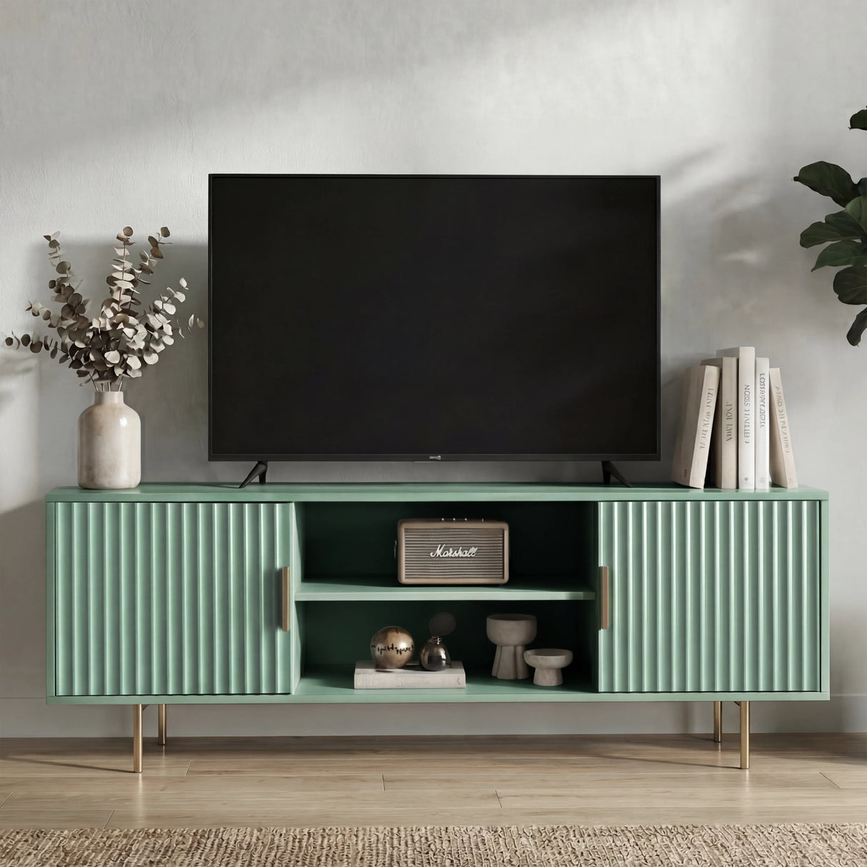 Modern green TV stand featuring vertical fluted doors and silver legs for a soft, contemporary living room accent.