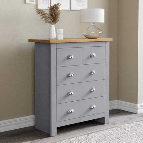 Grey and oak chest of drawers with handles, combining style and functionality