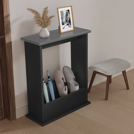 Black shoe rack with shoes, a vase, and a framed picture on a gray surface in a room.