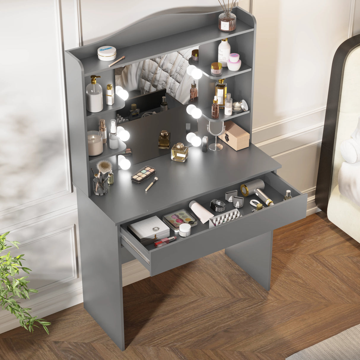 Grey vanity with mirror and lights featuring five open drawer filled with makeup essentials