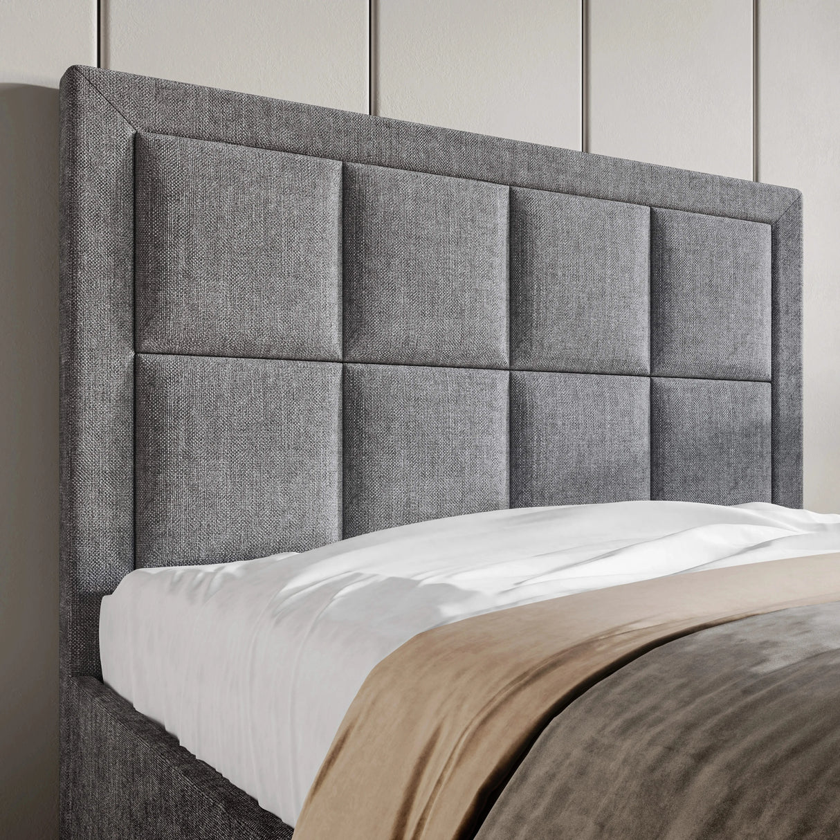 Close-up of the upholstered headboard on the single ottoman bed frame, showcasing a modern panelled design in grey fabric.