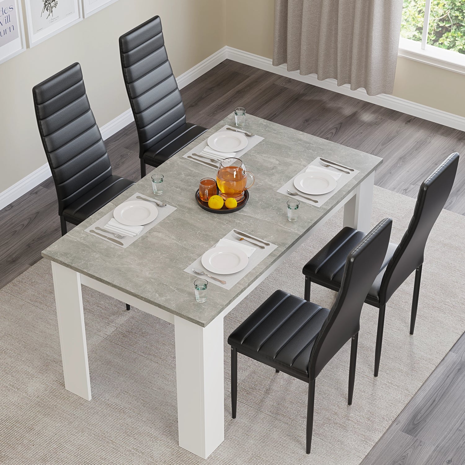 Top view of grey marble dining table set with 4 black chairs, styled with plates and glasses for a modern dining setup.