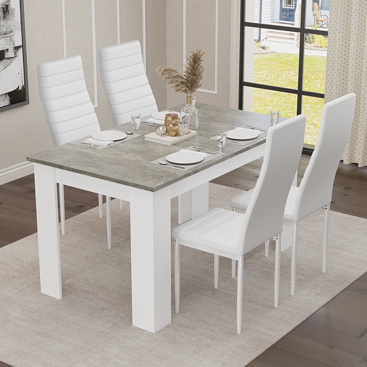 Stylish grey marble dining table with white legs and white chairs from, ideal for compact dining spaces and kitchens.